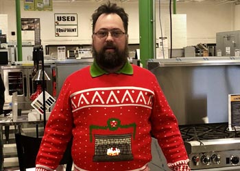 Bob Schall poses with his ugly Christmas sweater