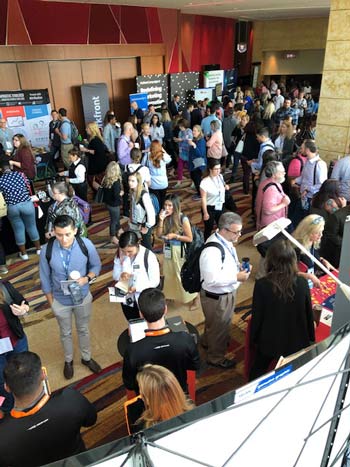 Digital Summit attendees network and visit the various exhibitor booths to learn about offerings and collect swag.
