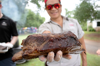 Restaurant Owner Howard Hsu holding barbeque beef