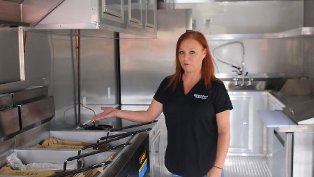 Kori Peterson, above, shows off one of Inglewood Custom and Service's food truck designs from its new facility in Eastman, Ga.