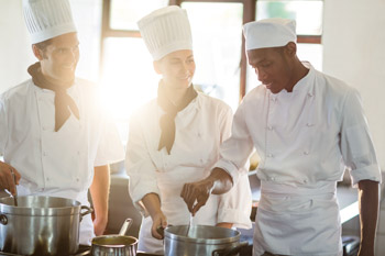 Head chef working together with her colleagues