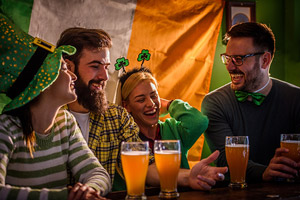 A group of people celebrate St. Patrick's Day at the bar